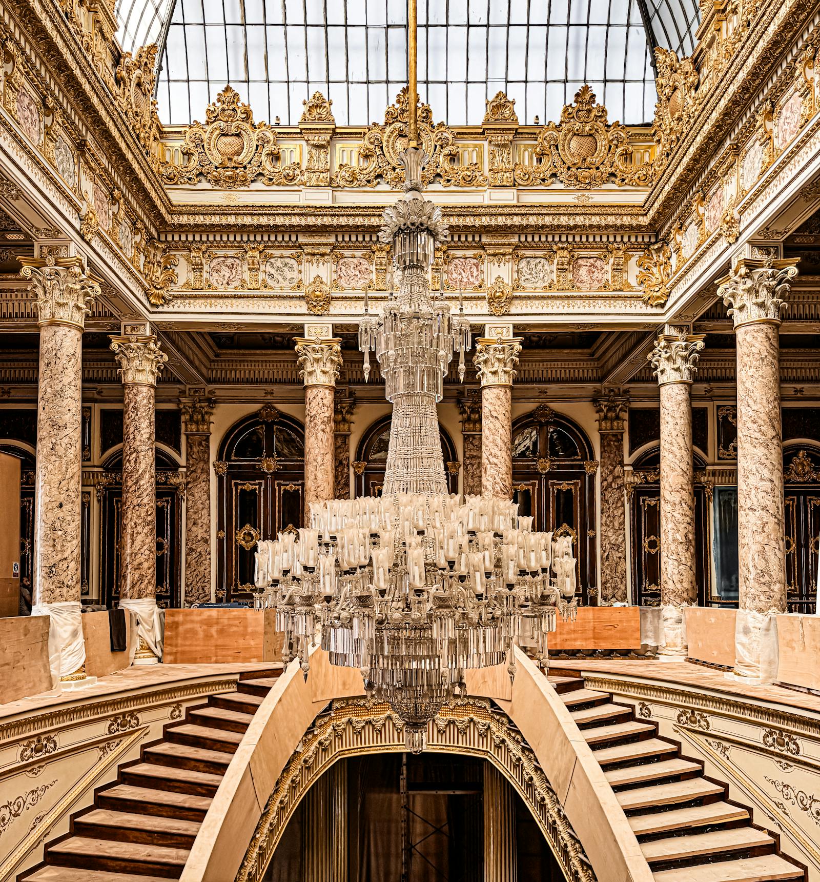 An opulent grand staircase rising beneath a crystal chandelier - a visual metaphor for the non-linear climb of rating improvement.